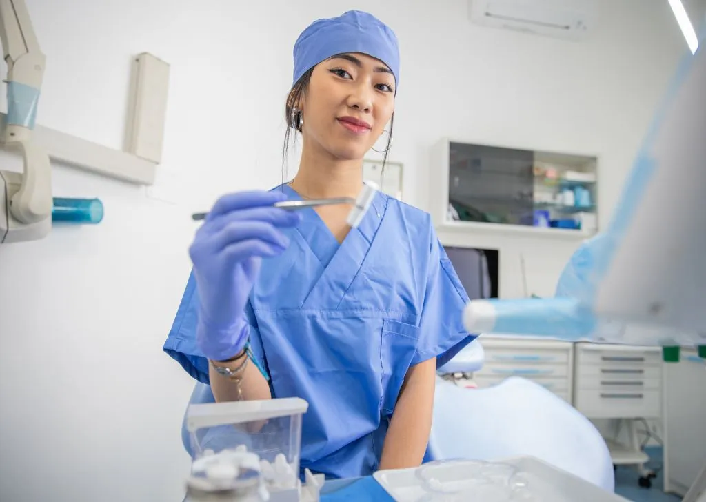 A professional dentist preparing for her patient.