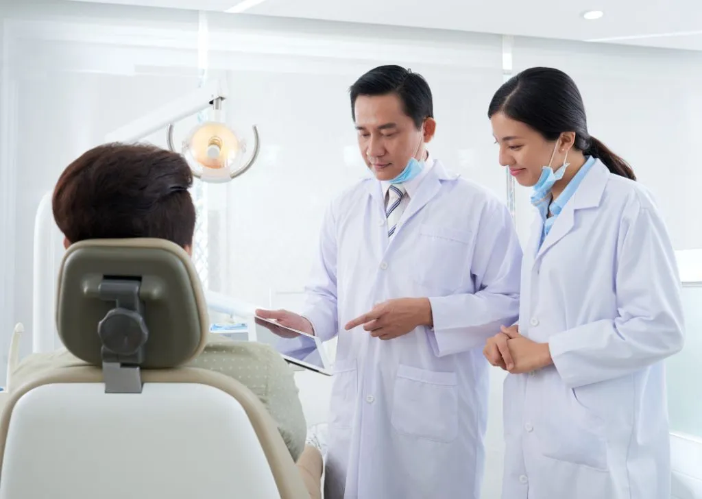 A dentist explaining to a patient what to do after their dentist appointment.