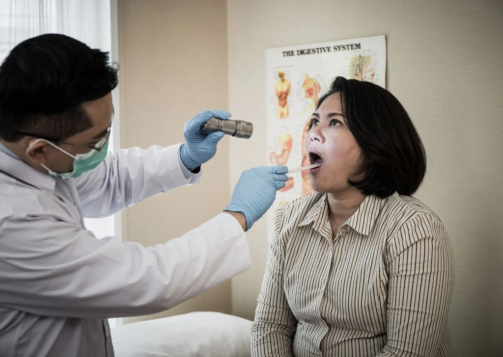 A patient getting an oral examination during her dentist appointment.