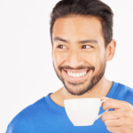 Man with white teeth drinking coffee